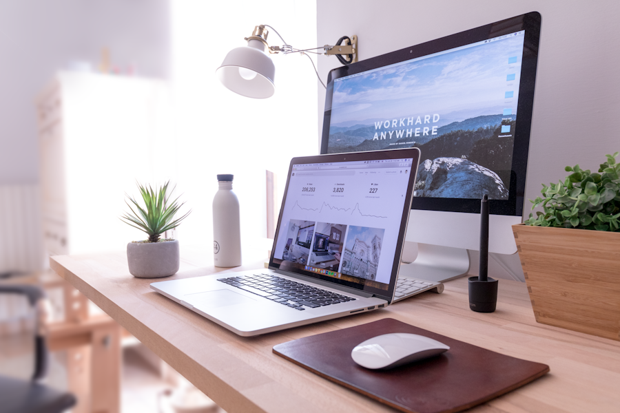 Modern web workspace with laptop and desktop